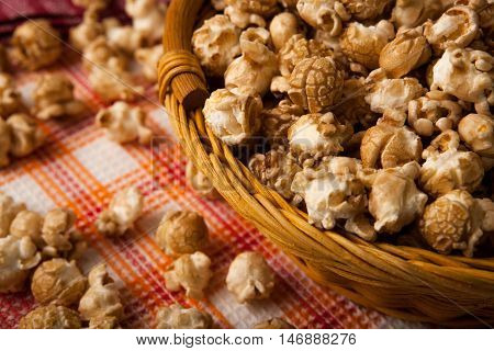 caramel popcorn in a basket on a napkin close up
