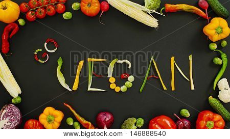 Vegetables made word go vegan. Vegetables made of word go vegan. Vegetables on a black background. Word go vegan on a black background.