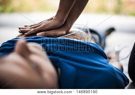 girl making CPR and heart massage to an unconscious man
