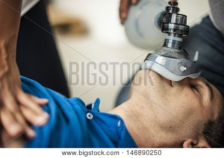 people making CPR to an unconscious man