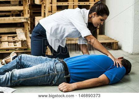 girl assisting an unconscious man after fatal accident