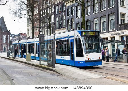 Amsterdam, Netherlands - March 31, 2016: Tram 1 running in city centre to Central Station, Amsterdam