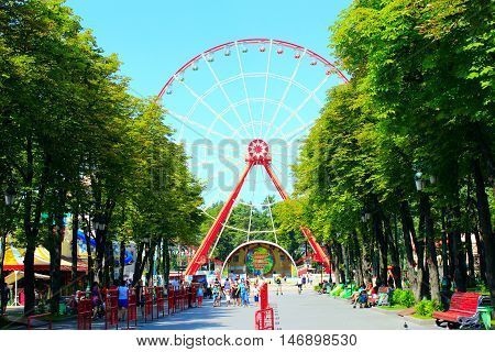 Kharkiv / Ukraine. 07 August 2016: view to ferris wheel and people walk in Gorky park in Kharkiv. 07 August 2016 in Kharkiv / Ukraine.