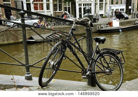 Bicycle in Amsterdam in front of the canals