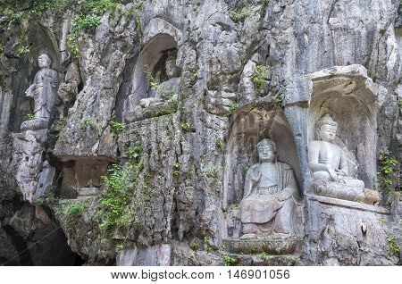 Rock reliefs at Feilai Feng grottos near Lingyin Temple in Hangzhou, China. In Feilai Feng a large number of rock reliefs dot the surface of the peak and are located in various caves and grottoes.