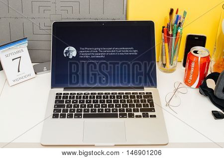 PARIS FRANCE - SEP 8 2016: Apple Computers website on MacBook Retina in room environment showcasing live coverage of Apple Keynote - presentation of iPhone new photo camera double camera