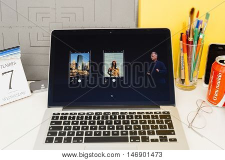 PARIS FRANCE - SEP 8 2016: Apple Computers website on MacBook Retina in room environment showcasing live coverage of Apple Keynote - presentation of iPhone new photo camera double camera