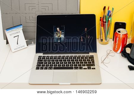 PARIS FRANCE - SEP 8 2016: Apple Computers website on MacBook Retina in room environment showcasing live coverage of Apple Keynote - presentation of iPhone new photo camera double camera