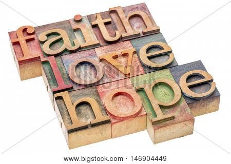 biblical, spiritual  or metaphysical reminder - faith, hope and love - word abstract in letterpress wood type blocks, stained by colorful inks, isolated on white