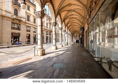 Turin, Italy - June 12, 2016: Street view with arch gallery and beautiful buildings in the center of Turin old town in Piedmont region in Italy