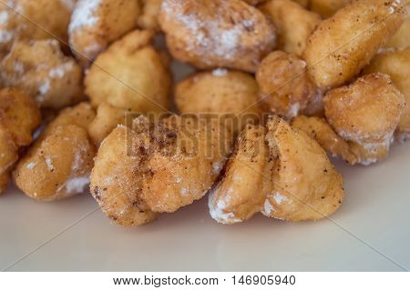 Ustipci, doughnut-like fried dough balls with sugar