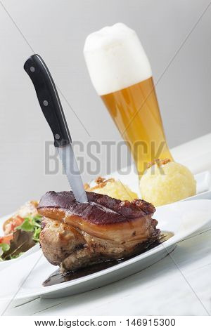 frankonian schaeufele roasted pork portion on grey
