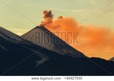 Emission ash from a volcano Klyuchevskoy dawn rays of the sun.