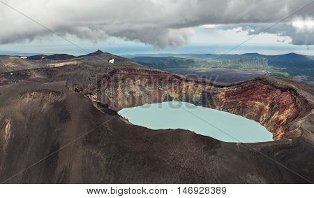 Maly Semyachik is a stratovolcano with acidic crater lake. Kronotsky Nature Reserve on Kamchatka Peninsula. View from helicopter.