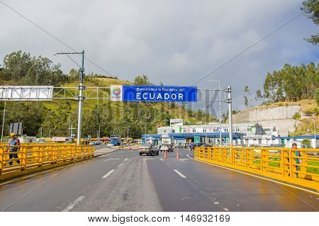 TULCAN, ECUADOR - JULY 3, 2016: cars and people crossing the borderline between Ecuador and colombia