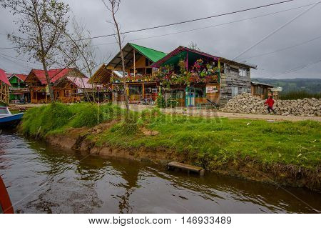 PASTO, COLOMBIA - JULY 3, 2016: some houses located next to the shore in la cocha lake close to the city of pasto.