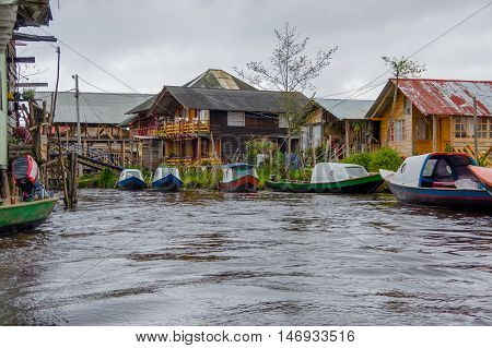 PASTO, COLOMBIA - JULY 3, 2016: some boats parked on the side of the small river close to la cocha lake.