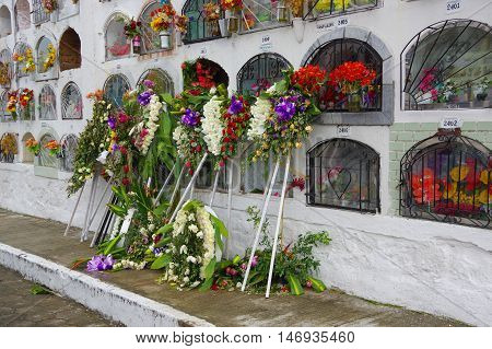 TULCAN, ECUADOR - JULY 3, 2016: some floral decorations outside of the vertical graves.