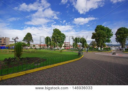TULCAN, ECUADOR - JULY 3, 2016: some pedestrians walking in a traditional park of the city.