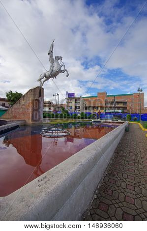 TULCAN, ECUADOR - JULY 3, 2016: the statue of simon bolivar riding a horse is located in an important park of the city.