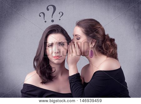 A teenager girl looking confused with drawn question marks above the head, while a girlfriend whispers something in her ear concept.