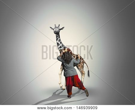 Young woman giving color to a black and white girrafe with a roller