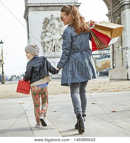 Mother And Child In Paris, France Looking Aside And Walking