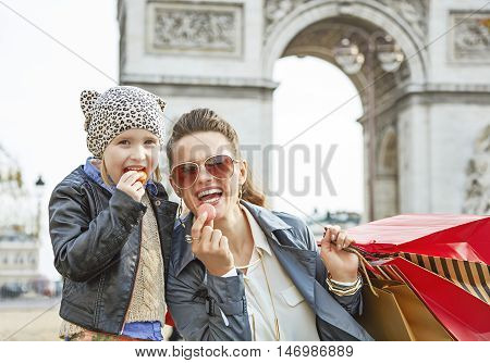 Mother And Daughter Near Arc De Triomphe Eating Macaroons