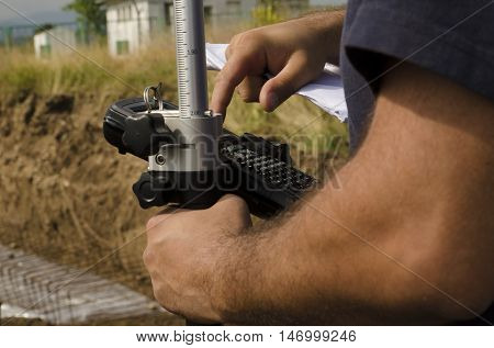Geodesist working with gps at a terrain