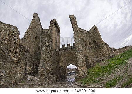 Genoese Fortress In Sudak, Crimea. Entrance To The Fortress, View From The Inside. Cloudy Day, Early