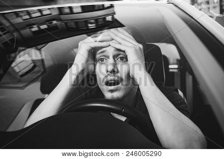 Accident. Young Caucasian Man Driving A Car Shocked About To Have Traffic Accident