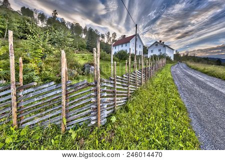 Norwegian House With Traditional White Wooden Fence