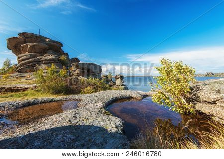 Bizarre forms of weathering of coastal rocks at the Kolyvan lake - a lake at the foot of the northern slope of the Kolyvan Ridge in the Altai Territory of Russia.