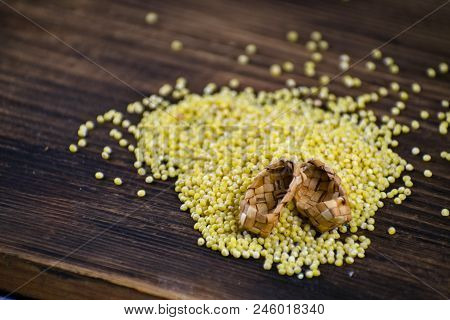 Millet In White Bowl On Brown Board. Bound Feet. Healthy Dietary Groats Background.