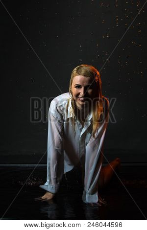 Nice Girl In The White Shirt And Water Drops Behind And Arround Her Illuminated By Light During A Ph