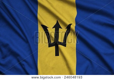 Barbados Flag  Is Depicted On A Sports Cloth Fabric With Many Folds. Sport Team Waving Banner