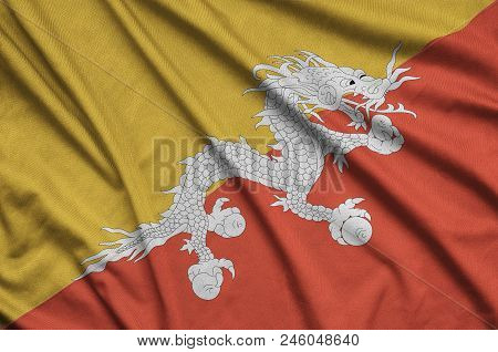 Bhutan Flag  Is Depicted On A Sports Cloth Fabric With Many Folds. Sport Team Waving Banner