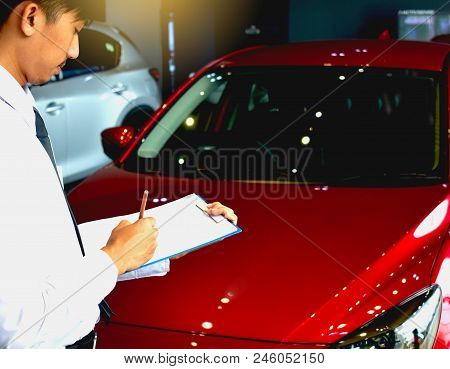 Career Man Saleman Business Inspection Writing On Notepad Or Book, Paper With Car Blurry Background.