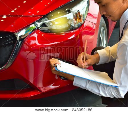 Career Man Saleman Business Inspection Writing On Notepad Or Book, Paper With Car Blurry Background.