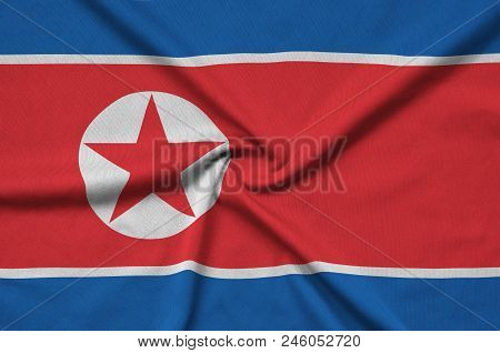 North Korea Flag  Is Depicted On A Sports Cloth Fabric With Many Folds. Sport Team Waving Banner