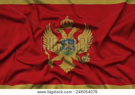 Montenegro Flag  Is Depicted On A Sports Cloth Fabric With Many Folds. Sport Team Waving Banner