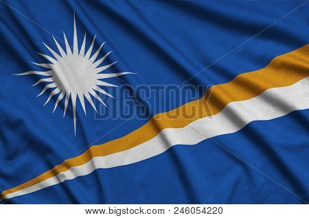 Marshall Islands Flag  Is Depicted On A Sports Cloth Fabric With Many Folds. Sport Team Waving Banne