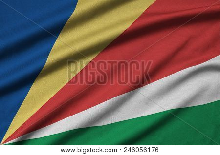 Seychelles Flag  Is Depicted On A Sports Cloth Fabric With Many Folds. Sport Team Waving Banner