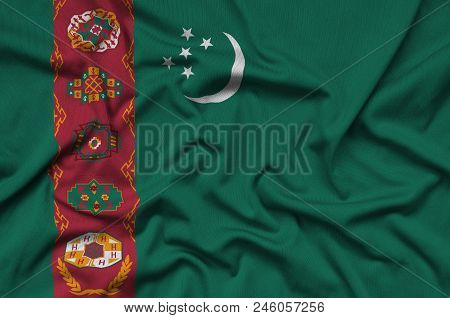 Turkmenistan Flag  Is Depicted On A Sports Cloth Fabric With Many Folds. Sport Team Waving Banner