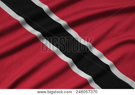 Trinidad And Tobago Flag  Is Depicted On A Sports Cloth Fabric With Many Folds. Sport Team Waving Ba
