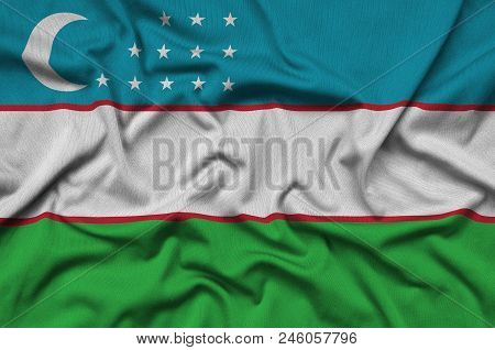 Uzbekistan Flag  Is Depicted On A Sports Cloth Fabric With Many Folds. Sport Team Waving Banner