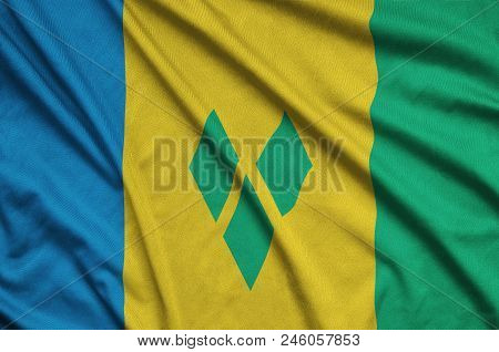 Saint Vincent And The Grenadines Flag  Is Depicted On A Sports Cloth Fabric With Many Folds. Sport T