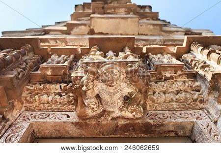 View Of Deity`s, And Tops Of The Khajuraho Temple Complex Against The Background Of The Blue Sky.