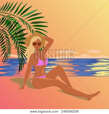 Tan Girl Dressed In A Pink Bikini Sits On The Beach Of The Sea And Looks At The Sunset