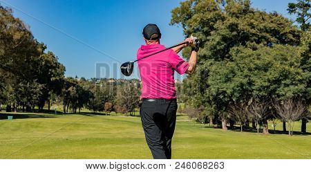 Man Teeing Off On A Golf Course Tee With A Driver Club